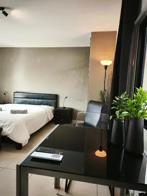 a bedroom with a bed and a desk with a computer at 103 St Lazaros View Studio in Larnaka