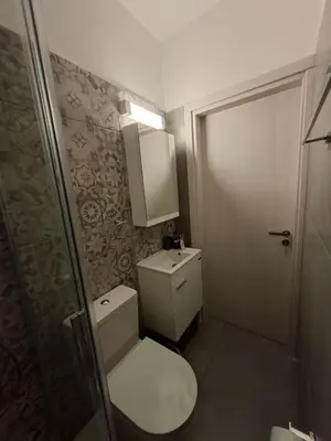 a small bathroom with a toilet and a sink at Luxury central 1BR with city view in Larnaka