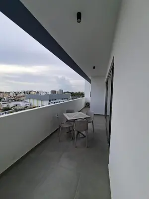an apartment with a balcony with a table and chairs at Luxury central 1BR with city view in Larnaka