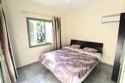 a bedroom with a bed and a window at Cozy flat by the sea with big pool tourist area in Limassol