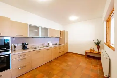 a large kitchen with wooden cabinets and appliances at STAY Hillcrest Panorama Villa in Moniatis