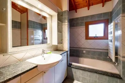 a bathroom with a sink and a bath tub at STAY Hillcrest Panorama Villa in Moniatis