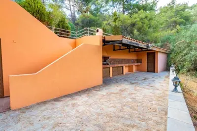 an orange house with a staircase at STAY Hillcrest Panorama Villa in Moniatis
