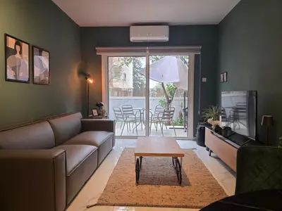 a living room with a couch and a table at Pop Art Residence by Staycom in Nicosia