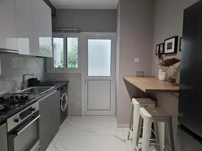 a kitchen with a counter and a sink and a door at Pop Art Residence by Staycom in Nicosia