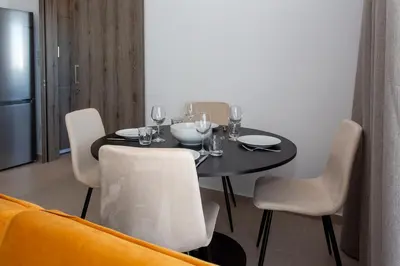 a black table with chairs and wine glasses on it at BlueBell Limassol Suites in Limassol