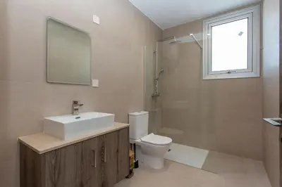 a bathroom with a sink and a toilet and a mirror at BlueBell Limassol Suites in Limassol