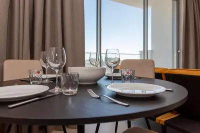 a black table with glasses and plates on it at BlueBell Limassol Suites in Limassol