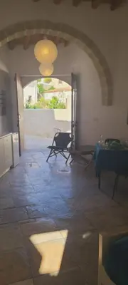 a room with an archway and a room with a table at Cottage Studio Zoe in Psematismenos