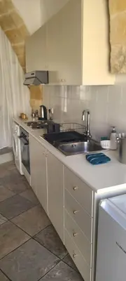 a kitchen with a sink and a stove at Cottage Studio Zoe in Psematismenos
