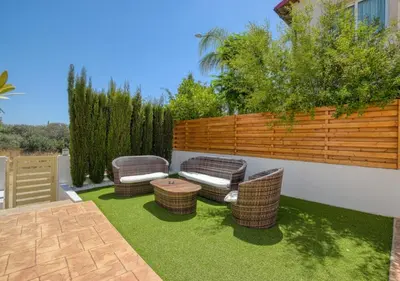 a patio with wicker chairs and a wooden fence at Villa Anais - 3-Bed Villa with Private Pool in Paralimni
