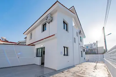 a white building with a roof at TelMar White House - 100m from the Sea in Voroklini