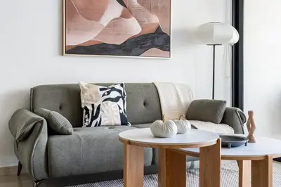 a living room with a couch and a table at Odin 1-BR Apartment & Balcony in Larnaca in Larnaka