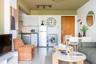 a kitchen and living room with a couch and a table at Odin 1-BR Apartment & Balcony in Larnaca in Larnaka