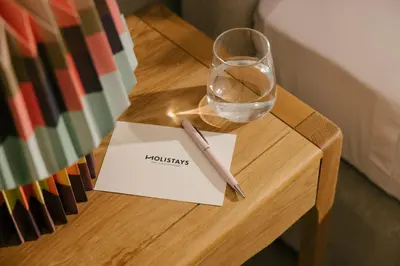 a table with a glass and a pen and a napkin at Pinewood by Holistays in Engomi