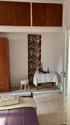 a bedroom with a bed and a tapestry on the wall at Coast & City Apartment in Limassol