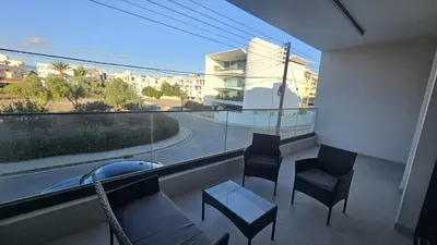 a balcony with chairs and a table and a large window at STAY Engomi Gem 1 in Engomi