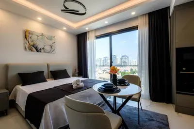 a bedroom with a bed and a table with chairs at Panorama Comfort Suita in Protaras