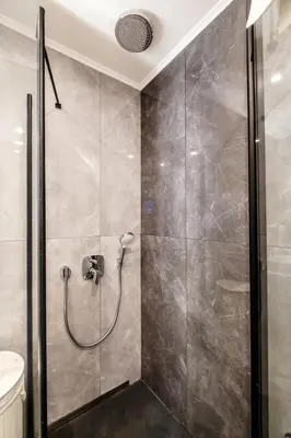 a bathroom with a shower with a shower head at Panorama Comfort Suita in Protaras