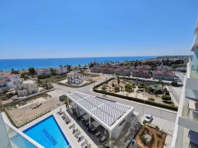 a view of a city with a building and the ocean at Panorama Comfort Suita in Protaras