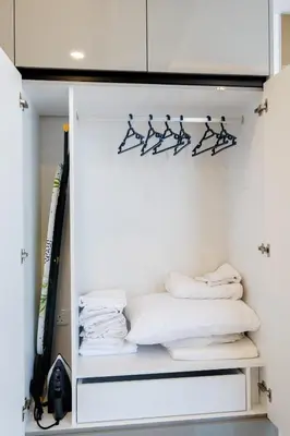 a closet filled with white towels and hangers at Panorama Comfort Suita in Protaras