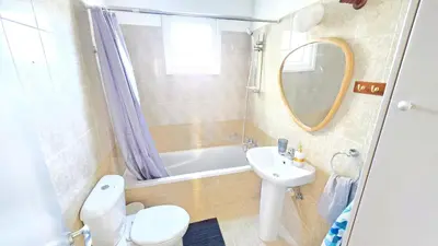 a bathroom with a sink and a toilet and a tub at 2 Apartments Retreat with Pool & Free Wi-Fi in Larnaka