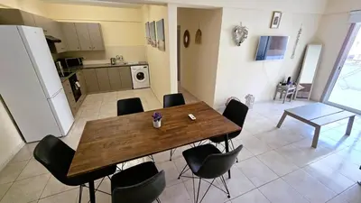 a dining room table and chairs in a kitchen at 2 Apartments Retreat with Pool & Free Wi-Fi in Larnaka