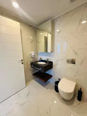 a bathroom with a toilet and a sink at Grand Sapphire Casino, High Floor, Sea View in Lythrodontas