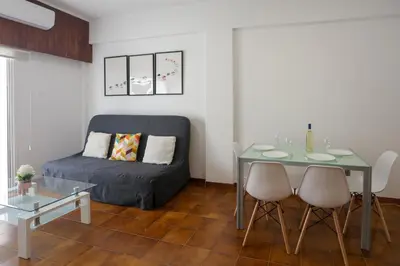 a living room with a couch and a table at Palmove Makenzy Charming 1Bed Apt in Larnaka