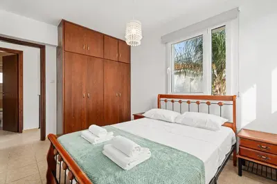 a bedroom with a bed with two towels on it at Villa St George - 3 Bed Villa with Private Pool in Xylophaghou