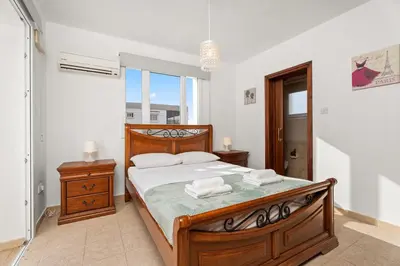 a bedroom with a bed with two towels on it at Villa St George - 3 Bed Villa with Private Pool in Xylophaghou