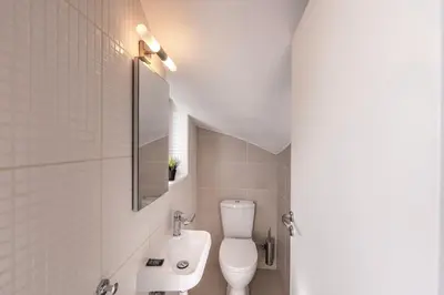 a white bathroom with a toilet and a sink at Protaras Seaside Villa Narcissos 2 in Protaras