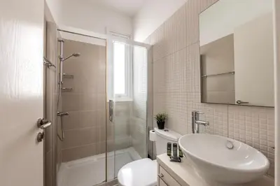 a white bathroom with a sink and a shower at Protaras Seaside Villa Narcissos 2 in Protaras