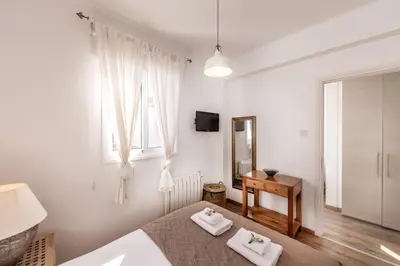 a white bedroom with a bed and a window at Protaras Seaside Villa Narcissos 2 in Protaras