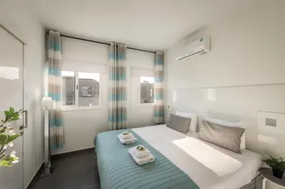 a bedroom with a bed with towels on it at Protaras Villa Alina in Protaras