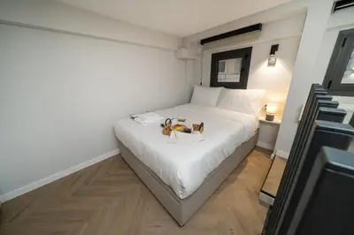 a bedroom with a white bed with a dog on it at New luxury studio in the historic center in Limassol