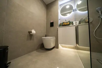 a bathroom with a toilet and a glass shower at New luxury studio in the historic center in Limassol