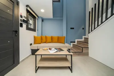 a living room with a couch and a table at New luxury studio in the historic center in Limassol