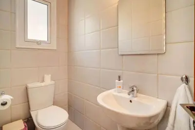 a bathroom with a toilet and a sink at Pernera Sunrise Villa in Paralimni