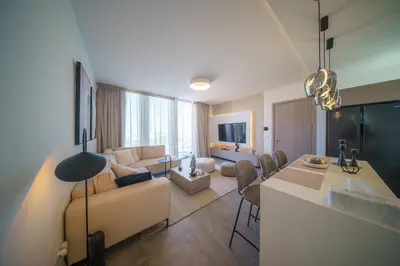 a living room with a couch and a table at Blue Horizon Seaview Suite with Rooftop and Pool in Paralimni in Paralimni
