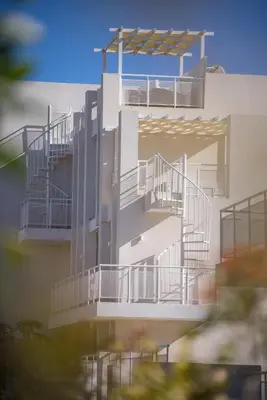 a building with stairs on the side of it at Blue Horizon Seaview Suite with Rooftop and Pool in Paralimni in Paralimni