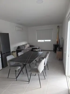 a dining room with a black table and chairs at Selladi Mountain Escape in Ephtagonia