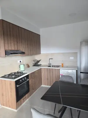 a kitchen with a stove and a sink and a table at Selladi Mountain Escape in Ephtagonia