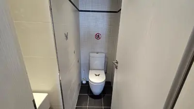 a small bathroom with a toilet in a stall at Sea View Apartment Finikoudes in Larnaka
