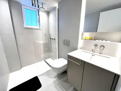 a bathroom with a toilet and a sink and a shower at STAY Atalanta Apartment in Larnaka