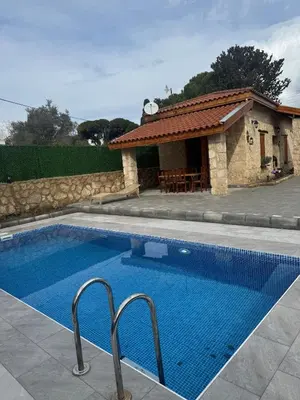 a swimming pool in front of a house at Stone house in Pallouriotissa
