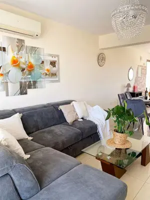 a living room with a couch and a table at Summer Breeze apt by Nissi Beach in Ayia Napa