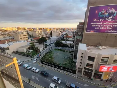 an overhead view of a city with cars on a street at Limassol City Center in Limassol