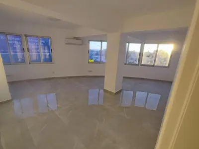 an empty room with white walls and windows at Limassol City Center in Limassol