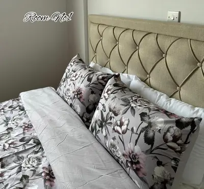 a bed with a floral bedspread and pillows on it at CityLink-3Bedrooms Appartment CityCenter in Limassol